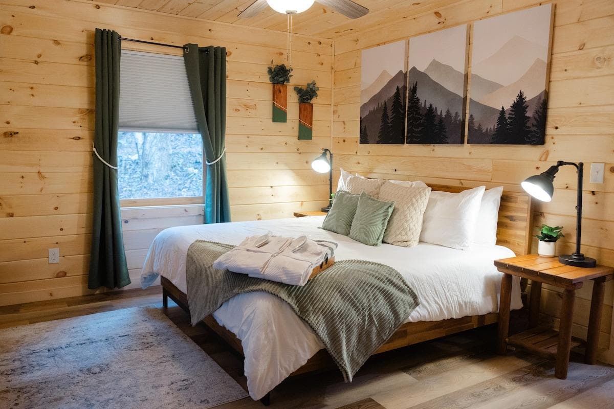 Unleash your passion in our mountaintop haven. A king-sized bed beckons, with soft sheets beneath a mesmerizing mural. Indulge in intimate moments with your loved one. Plush robes and slippers await. Let the magic of the mountains ignite your desire.